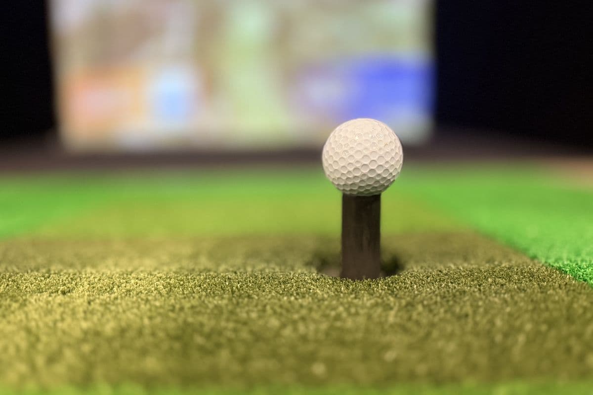 Golf ball on turf inside Golf Paradise Club