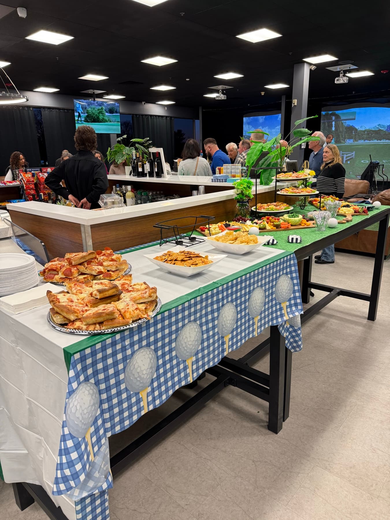 Birthday party food setup beside Golf Paradise Club simulator bays