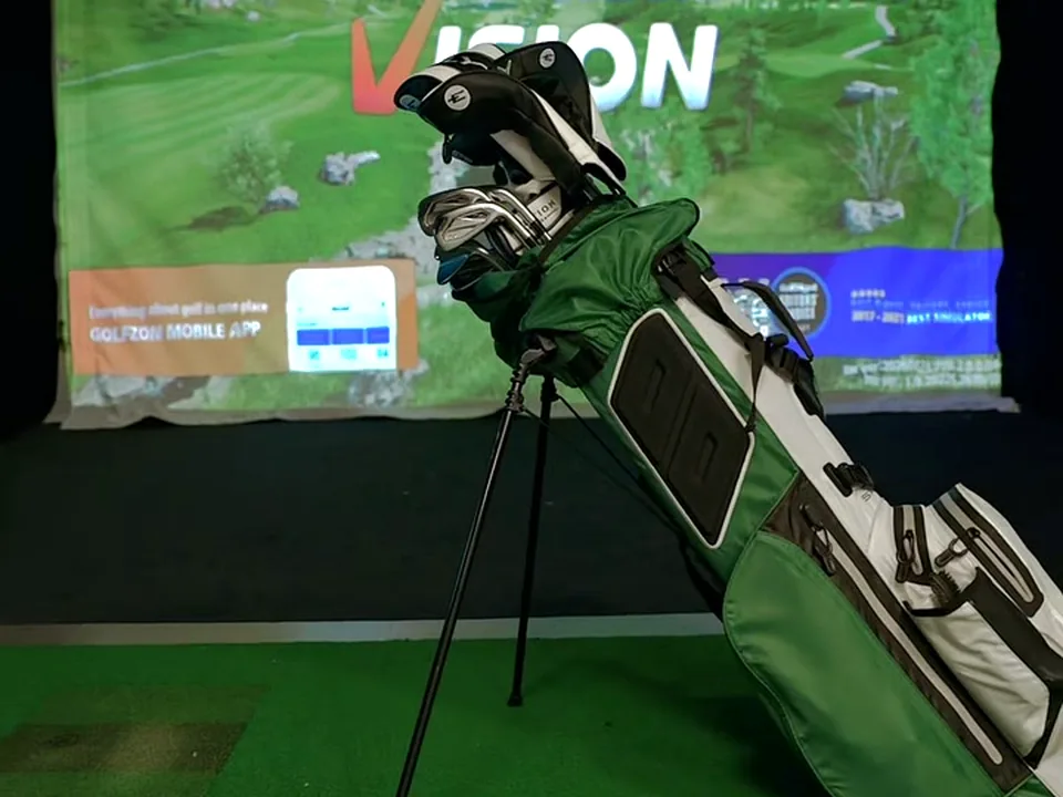 Golf bag in front of a GOLFZON simulator screen at Golf Paradise Club
